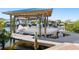 Covered boat lift with dock access at 6518 Senegal Palm Way, Apollo Beach, FL 33572