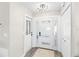 Bright and airy entryway with modern doors and stylish light fixture at 6518 Senegal Palm Way, Apollo Beach, FL 33572