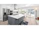 Modern kitchen with stainless steel appliances and large island at 6518 Senegal Palm Way, Apollo Beach, FL 33572