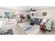 Open living space with pool views, featuring a comfy sofa and rug at 6518 Senegal Palm Way, Apollo Beach, FL 33572