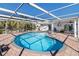 Relaxing kidney-shaped pool with screened enclosure at 6518 Senegal Palm Way, Apollo Beach, FL 33572