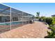 Spacious patio with brick pavers, screened pool, and seating area at 6518 Senegal Palm Way, Apollo Beach, FL 33572