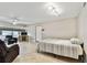 Bedroom with striped bedspread, ceiling fan, and access to living room at 7701 Starkey Rd # 105, Seminole, FL 33777