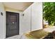 Condo building entryway with a dark brown door and light-colored walls at 7701 Starkey Rd # 105, Seminole, FL 33777