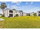 Community view with grassy lawn and building at 7701 Starkey Rd # 105, Seminole, FL 33777
