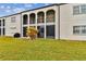 Building exterior with arched doorways, balconies, and green lawn at 7701 Starkey Rd # 105, Seminole, FL 33777