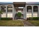 Two-story building exterior with walkway and landscaping at 7701 Starkey Rd # 105, Seminole, FL 33777