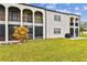 Building exterior showcasing balconies, arched entryways, and a patio at 7701 Starkey Rd # 105, Seminole, FL 33777