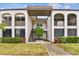 Two-story building exterior with walkway and landscaping at 7701 Starkey Rd # 105, Seminole, FL 33777