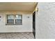 Building exterior showing entrance with a black door and window at 7701 Starkey Rd # 105, Seminole, FL 33777