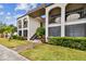 Two-story building exterior with walkway and landscaping at 7701 Starkey Rd # 105, Seminole, FL 33777