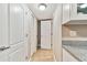 Hallway with white doors and light beige walls at 7701 Starkey Rd # 105, Seminole, FL 33777