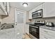 Kitchen with stainless steel appliances and granite countertops at 7701 Starkey Rd # 105, Seminole, FL 33777