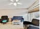Living room with two sofas, a coffee table, and a ceiling fan at 7701 Starkey Rd # 105, Seminole, FL 33777
