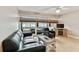 Living room with black leather couch, chair, and a fireplace at 7701 Starkey Rd # 105, Seminole, FL 33777