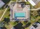 Community pool with patio, lounge chairs and shaded seating at 7701 Starkey Rd # 105, Seminole, FL 33777
