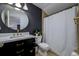 Stylish bathroom with dark vanity and gold fixtures at 8131 Spring Forest Ln, Wesley Chapel, FL 33544
