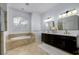 Elegant bathroom with double vanity, soaking tub, and separate shower at 8131 Spring Forest Ln, Wesley Chapel, FL 33544