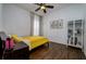 Bedroom with yellow bedding and wood flooring at 8131 Spring Forest Ln, Wesley Chapel, FL 33544