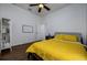 Bedroom with yellow bedding and wood floors at 8131 Spring Forest Ln, Wesley Chapel, FL 33544