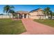 Two-story house with solar panels, large driveway, and palm trees at 8131 Spring Forest Ln, Wesley Chapel, FL 33544