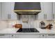 Modern kitchen with gas cooktop and unique backsplash at 8131 Spring Forest Ln, Wesley Chapel, FL 33544