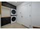 Convenient laundry room with stacked washer and dryer at 8131 Spring Forest Ln, Wesley Chapel, FL 33544