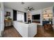 Bright living room features a white sectional sofa, fireplace, and built-in shelving at 8131 Spring Forest Ln, Wesley Chapel, FL 33544