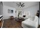 Spacious living area with a white sectional sofa and a view into the kitchen at 8131 Spring Forest Ln, Wesley Chapel, FL 33544