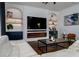Living room boasts a modern fireplace, built-in shelving, and a large TV at 8131 Spring Forest Ln, Wesley Chapel, FL 33544