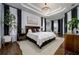 Large main bedroom with a king-size bed and sitting area at 8131 Spring Forest Ln, Wesley Chapel, FL 33544