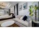 Bedroom sitting area features a light-grey sofa with blue throw pillows at 8131 Spring Forest Ln, Wesley Chapel, FL 33544