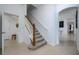 Elegant staircase with wood railing and carpeted steps at 8131 Spring Forest Ln, Wesley Chapel, FL 33544