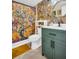 Bathroom with green vanity, floral wallpaper, and walk-in shower at 90 S Highland Ave # 423, Tarpon Springs, FL 34689