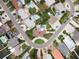 Aerial view showcasing home's location in a residential neighborhood with pools and lush landscaping at 911 Boca Ciega Isle Dr, St Pete Beach, FL 33706