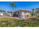 Side view of a single story home with landscaping at 911 Boca Ciega Isle Dr, St Pete Beach, FL 33706