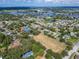 Aerial view showing community with tennis courts and sports field at 1004 Peninsula Ave, Tarpon Springs, FL 34689