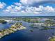 Wide aerial view of a waterfront community with lush landscaping at 1004 Peninsula Ave, Tarpon Springs, FL 34689