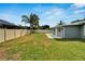 Large backyard with grassy area and privacy fence at 1004 Peninsula Ave, Tarpon Springs, FL 34689