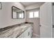 Modern bathroom with granite countertop and large mirror at 1004 Peninsula Ave, Tarpon Springs, FL 34689