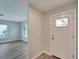 Bright entryway with a white door and wood-look flooring at 1004 Peninsula Ave, Tarpon Springs, FL 34689