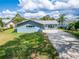 Attractive light blue home with a long driveway at 1004 Peninsula Ave, Tarpon Springs, FL 34689