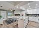 Modern white kitchen with granite countertops and stainless steel appliances at 1004 Peninsula Ave, Tarpon Springs, FL 34689