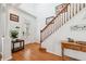 Bright entryway with hardwood floors, staircase, and decorative accents at 10515 Fenceline Rd, New Port Richey, FL 34655