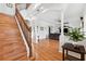 Bright entryway with hardwood floors, staircase, and decorative accents at 10515 Fenceline Rd, New Port Richey, FL 34655