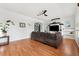 Bright living room featuring hardwood floors, a sectional sofa, and a fireplace at 10515 Fenceline Rd, New Port Richey, FL 34655