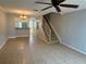 Bright living room featuring tile floors and a staircase at 11356 Stratton Park Dr, Temple Terrace, FL 33617