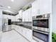 Modern kitchen with stainless steel appliances and white cabinetry at 11525 Lake Lucaya Dr, Riverview, FL 33579