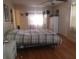 Spacious bedroom with large bed, dresser, and wood flooring at 1434 Cleveland St # 4, Clearwater, FL 33755