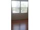 Bright bedroom with hardwood floors and two windows at 1434 Cleveland St # 4, Clearwater, FL 33755